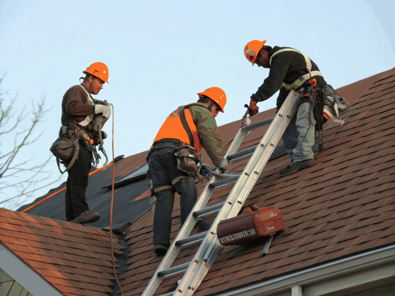 Professional roofers installing new shingles